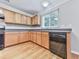 Modern kitchen featuring wood cabinets, black appliances, and ample counter space at 232 Oconee Way, Canton, GA 30114