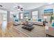 Bright living room with hardwood floors, recessed lighting, and stylish decor with blue accents at 232 Oconee Way, Canton, GA 30114