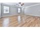 Bright living room features hardwood floors, neutral paint, and ceiling fan at 232 Oconee Way, Canton, GA 30114