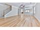 Open living area featuring hardwood floors, staircase, and view into the kitchen area at 232 Oconee Way, Canton, GA 30114