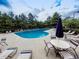 Outdoor pool area with lounge chairs, tables, and a calming wooded view at 232 Oconee Way, Canton, GA 30114