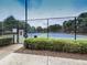 A tennis court in a fenced-in area with a manicured landscape at 232 Oconee Way, Canton, GA 30114