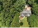Aerial view showcases a beautiful home nestled amongst lush greenery and a spacious backyard deck at 5020 Bayberry Dr, Cumming, GA 30040