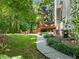 Beautiful backyard featuring a wooden deck, green grass, and mature trees at 5020 Bayberry Dr, Cumming, GA 30040