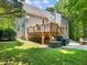 Backyard view showing the deck with stairs, grilling area, and manicured lawn at 5020 Bayberry Dr, Cumming, GA 30040