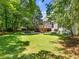 Backyard view showcasing the large manicured lawn, outdoor picnic area, and deck at 5020 Bayberry Dr, Cumming, GA 30040