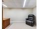 A comfortable chair sits in the basement near a desk and an entertainment center at 5020 Bayberry Dr, Cumming, GA 30040
