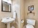 Charming powder room with pedestal sink, decorative mirror, and neutral color scheme at 5020 Bayberry Dr, Cumming, GA 30040