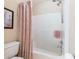 Bathroom including a shower/tub combination with a peach-colored shower curtain and chrome shower head at 5020 Bayberry Dr, Cumming, GA 30040