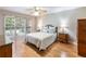Cozy bedroom with a large window, wood floors, ceiling fan and classic furnishings at 5020 Bayberry Dr, Cumming, GA 30040