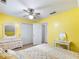 Bedroom featuring a bed, a dresser, closet, a ceiling fan, and yellow walls at 5020 Bayberry Dr, Cumming, GA 30040