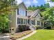 Charming home with stone accents, manicured lawn, and attached garage at 5020 Bayberry Dr, Cumming, GA 30040