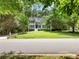 Charming home with a lush front yard and mature trees lining the street at 5020 Bayberry Dr, Cumming, GA 30040