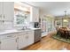 Bright kitchen area with stainless dishwasher, white cabinets, and adjacent breakfast nook at 5020 Bayberry Dr, Cumming, GA 30040