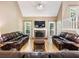 Bright living room with a fireplace, hardwood floors, and ample natural light at 5020 Bayberry Dr, Cumming, GA 30040
