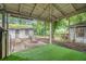 Covered patio offers shade to the outdoor space with backyard access and landscaping at 724 Bellemeade Nw Ave, Atlanta, GA 30318
