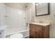Well-lit bathroom features a tub/shower combo and vanity with sink and cabinet at 724 Bellemeade Nw Ave, Atlanta, GA 30318