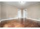 Neutral bedroom features hardwood floors, trim, and multiple doors offering flexible layout options at 724 Bellemeade Nw Ave, Atlanta, GA 30318