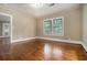 Spacious bedroom featuring hardwood floors, natural light from a window, and soft, neutral walls at 724 Bellemeade Nw Ave, Atlanta, GA 30318