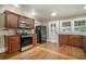 Well-lit kitchen with hardwood floors, updated appliances and wooden cabinets at 724 Bellemeade Nw Ave, Atlanta, GA 30318