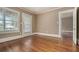 Bright living room with hardwood floors and a view of the front yard through large windows at 724 Bellemeade Nw Ave, Atlanta, GA 30318