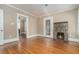 Inviting living room featuring a stone fireplace and gleaming hardwood floors at 724 Bellemeade Nw Ave, Atlanta, GA 30318