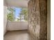 Enclosed porch features natural light from a large wall of windows and stone pillar at 724 Bellemeade Nw Ave, Atlanta, GA 30318