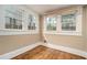 Small empty room displays three windows allowing plenty of natural light over hardwood floors at 724 Bellemeade Nw Ave, Atlanta, GA 30318