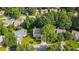 Aerial view of a charming home with mature trees and a lush green lawn on a well-maintained street at 740 Paris Dr, Lawrenceville, GA 30043
