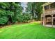 Expansive fenced-in backyard featuring a patio and tiered wooden deck at 740 Paris Dr, Lawrenceville, GA 30043