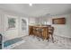 Bar area with a wooden bar, bar stools, and mirrors. A great space for entertaining at 740 Paris Dr, Lawrenceville, GA 30043