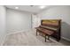 Basement room with gray carpet and an upright piano at 740 Paris Dr, Lawrenceville, GA 30043