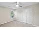 Cozy bedroom with neutral walls, soft carpet, a ceiling fan, and a double door closet at 740 Paris Dr, Lawrenceville, GA 30043