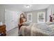 Well-lit bedroom with carpet, double closets, and large windows offering views of the outdoors at 740 Paris Dr, Lawrenceville, GA 30043