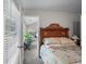 Comfortable bedroom featuring a wooden sleigh bed and natural light from a window with blinds at 740 Paris Dr, Lawrenceville, GA 30043