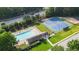 Aerial view shows a community pool, tennis courts, playground, and clubhouse in a meticulously maintained area at 740 Paris Dr, Lawrenceville, GA 30043