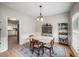 Formal dining room with decorative rug, chandelier, and wainscoting at 740 Paris Dr, Lawrenceville, GA 30043