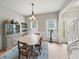 Sunlit dining room featuring white wainscoting, and a vintage cabinet for storage and display at 740 Paris Dr, Lawrenceville, GA 30043