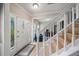 Bright foyer featuring a staircase, hardwood floors, and a view into the adjacent living spaces at 740 Paris Dr, Lawrenceville, GA 30043