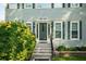 Charming front entrance with a green door, well-manicured landscaping, and black shutters at 740 Paris Dr, Lawrenceville, GA 30043