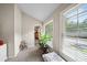 Well-lit hallway with carpet, large windows, and a view into another room at 740 Paris Dr, Lawrenceville, GA 30043
