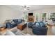 Comfortable living room with a fireplace, large windows, and stylish decor, ideal for relaxation at 740 Paris Dr, Lawrenceville, GA 30043