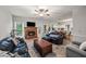 Open-concept living room and kitchen area featuring a brick fireplace and hardwood floors, great for gatherings at 740 Paris Dr, Lawrenceville, GA 30043