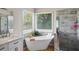 Bright main bathroom with soaking tub, glass shower, double sinks and natural light at 740 Paris Dr, Lawrenceville, GA 30043