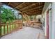 Concrete patio with wooden railing overlooking the landscaped backyard at 740 Paris Dr, Lawrenceville, GA 30043