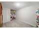 Spare room offering built in shelving and neutral gray carpet at 740 Paris Dr, Lawrenceville, GA 30043