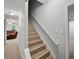 Staircase with wooden steps and a white railing, leading to other levels of the home at 740 Paris Dr, Lawrenceville, GA 30043