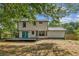 Two-story home featuring a large backyard with a wooden deck and unique, blue double doors at 8649 Cedar Creek Rdg, Riverdale, GA 30274