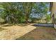 Spacious backyard featuring a deck, tall mature trees providing shade, and a wooden fence at 8649 Cedar Creek Rdg, Riverdale, GA 30274