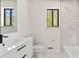 Modern bathroom featuring a sleek vanity, toilet, marble accent wall, and natural light at 8649 Cedar Creek Rdg, Riverdale, GA 30274